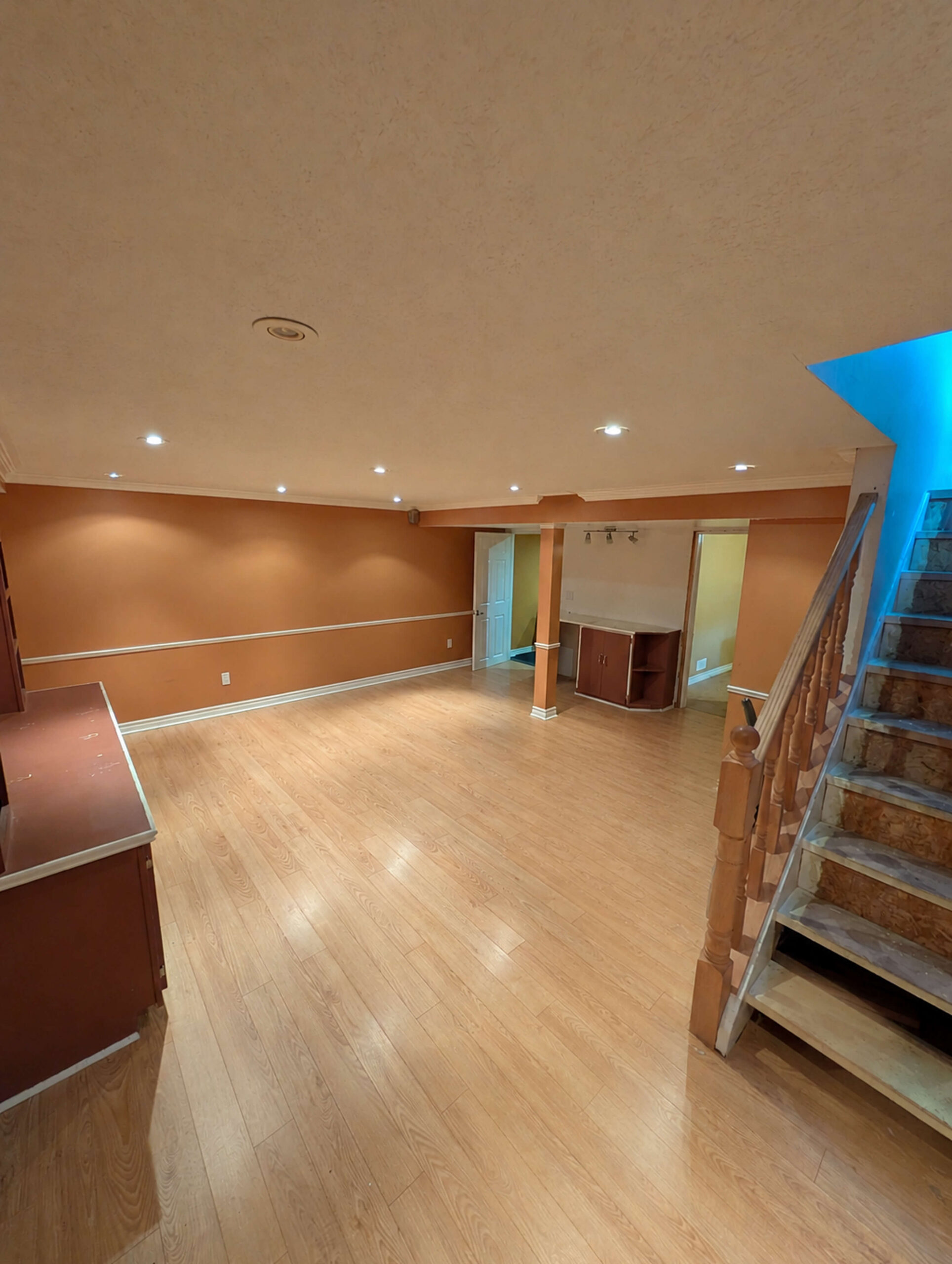 Before photo of a bathroom renovation project showing open space with recessed lighting and warm-toned walls, ready for custom renovation by Odyssey Custom Contracting